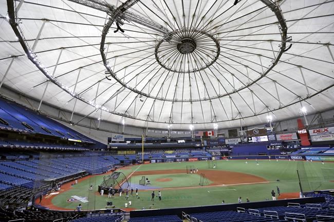 FILE - In this July 24, 2020, file photo, Members of the Tampa Bay Rays take batting practice at Tropicana Field before a baseball game against the Toronto Blue Jays in St. Petersburg, Fla. The Rays have a scheme to play half their home games in St. Petersburg and the other half in another city some 1,500 miles away. (AP Photo/Chris O'Meara, File)