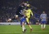 Brighton and Hove Albion goalkeeper Robert Sanchez collides with teammate Lewis Dunk in an attempt to clear the ball from Arsenal's Gabriel Magalhaes during the English Premier League soccer match at the AMEX Stadium, Brighton, England, Saturday Oct. 2, 2021. (Ashley Western/PA via AP)
