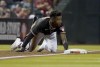 Arizona Diamondbacks' Geraldo Perdomo (2) holds onto the bag after hitting a triple against the Colorado Rockies during the third inning of a baseball game Saturday, Oct 2, 2021, in Phoenix. (AP Photo/Darryl Webb)