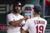 St. Louis Cardinals' Tommy Edman (19) gets a fist bump from teammate Matt Carpenter after their baseball game against the Chicago Cubs was called off due to weather Sunday, Oct. 3, 2021, in St. Louis. The Cubs won 3-2. (AP Photo/Jeff Roberson)