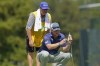 Trey Mullinax, right, discusses his putting strategy with his caddie on the first green during the final round of the Sanderson Farms Championship golf tournament in Jackson, Miss., Sunday, Oct. 3, 2021. (AP Photo/Rogelio V. Solis)