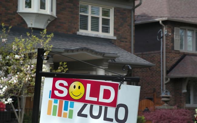 A sold sign is shown in front of west-end home in Toronto, Sunday, May 14, 2017. As the pandemic gives more people reason to move to smaller communities, insurance experts say homebuyers should be aware of higher home insurance premiums outside of larger cities. THE CANADIAN PRESS/Graeme Roy