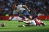 Tottenham's Harry Kane is tackled by Aston Villa's Jacob Ramsey during the English Premier League soccer match between Tottenham Hotspur and Aston Villa, at the Tottenham Hotspur stadium in London, Sunday, Oct. 3, 2021. (AP Photo/Ian Walton)