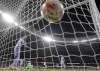 Barcelona's Gerard Pique looks round as Atletico Madrid's Luis Suarez, center rear, celebrates after scoring his side's second goal during the La Liga soccer match between Atletico Madrid and Barcelona at the Estadio Wanda Metropolitano in Madrid, Saturday, Oct. 2, 2021. (AP Photo/Manu Fernandez)