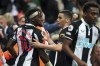 Newcastle's Allan Saint-Maximin, left, celebrates with teammates after scoring his side's first goal of the game during their English Premier League soccer match at St James' Park, Newcastle, England, Friday, Sept. 17, 2021. (Owen Humphreys/PA via AP)