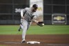 Chicago White Sox third baseman Yoan Moncada (10) fields a round ball by Houston Astros second baseman Jose Altuve (27) during the third inning in Game 2 of a baseball American League Division Series Friday, Oct. 8, 2021, in Houston. Altuve was out at first. (AP Photo/Eric Christian Smith)