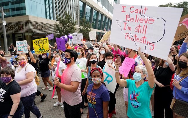FILE - In this Oct. 2, 2021 file photo people participate in the Houston Women's March against Texas abortion ban walk from Discovery Green to City Hall in Houston. A federal appeals court is temporarily allowing the nation’s toughest abortion law to resume in Texas. The 5th U.S. Circuit Court of Appeals handed down the order Friday, Oct. 8. (Melissa Phillip/Houston Chronicle via AP, File)