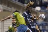 Seattle Sounders midfielder Josh Atencio, left, comes down from competing with Vancouver Whitecaps midfielder Leonard Owusu, right, for a header during the first half of an MLS soccer match Saturday, Oct. 9, 2021, in Seattle. (AP Photo/Ted S. Warren)