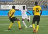 Canada's, Alphonso Davies, center, fights for the ball against Jamaica's Albas Powell, left, and Je-vaughn Watson during a qualifying soccer match for the FIFA World Cup Qatar 2022 at the Independence Park stadium in Kingston, Jamaica, Sunday, Oct. 10, 2021. THE CANADIAN PRESS/AP-Collin Reid