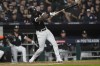 Chicago White Sox's Tim Anderson hits a single against the Houston Astros in the first inning during Game 3 of a baseball American League Division Series Sunday, Oct. 10, 2021, in Chicago. (AP Photo/Nam Y. Huh)