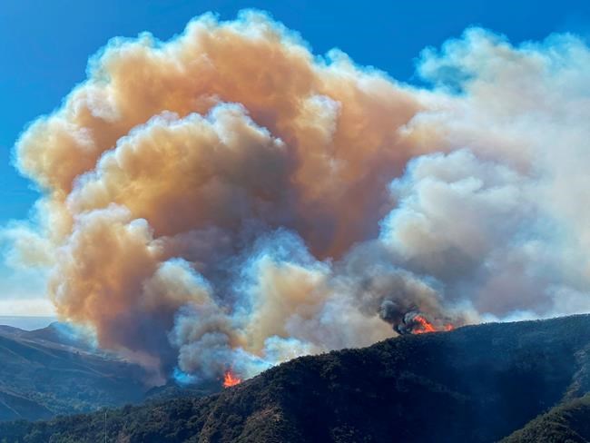 In this photo provided by Santa Barbara County Fire Department, the Alisal Fire continues to burn the dry vegetation in Refugio Canyon on Tuesday morning, Oct. 12, 2021, in Santa Barbara County, Calif. (Mike Eliason/Santa Barbara County Fire via AP)