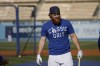 Los Angeles Dodgers third baseman Justin Turner holds a bat during batting practice before Game 4 of the baseball team's National League Division Series against the San Francisco Giants, Tuesday, Oct. 12, 2021, in Los Angeles. (AP Photo/Marcio Jose Sanchez)