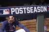 Atlanta Braves' Freddie Freeman sits in the dugout with his son, Charlie, far right, during a workout ahead of the NLCS playoff baseball game, Thursday, Oct. 14, 2021, in Atlanta. (AP Photo/Brynn Anderson)
