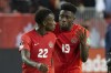 Canada's Alphonso Davies (right) speaks with teammate Richie Laryea after the final whistle following their 4-1 win over Panama in World Cup Qualifying action in Toronto, on Wednesday, October 13, 2021.THE CANADIAN PRESS/Chris Young