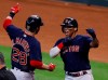 Boston Red Sox designated hitter J.D. Martinez celebrates with Rafael Devers after hitting a grand slam against the Houston Astros during the first inning in Game 2 of baseball's American League Championship Series Saturday, Oct. 16, 2021, in Houston.  (Kevin M. Cox/The Galveston County Daily News via AP)