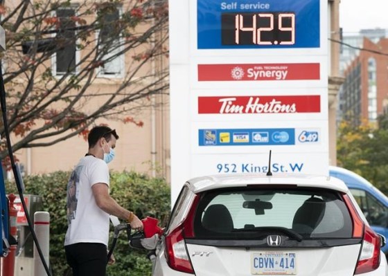 A man fills his vehicle with gas in Toronto on Friday, October 8, 2021.  THE CANADIAN PRESS/Nathan Denette