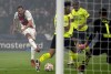 Ajax's Daley Blind, left, kicks the ball during the Champions League group C soccer match between Ajax and Borussia Dortmund at the Johan Cruyff ArenA in Amsterdam, Netherlands, Tuesday, Oct. 19, 2021. (AP Photo/Peter Dejong)