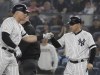 FILE - In this June 18, 2019, New York Yankees' Luke Voit, left, celebrates an RBI-single with first base coach Reggie Willits, right, during the fifth inning of a baseball game against the Tampa Bay Rays in New York. Yankees manager Aaron Boone lost a fourth member of his staff when New York announced Thursday, Oct. 21, 2021, that first base coach and outfield instructor Willits will leave at the end of the year to become a volunteer assistant for Oklahoma's college baseball program. (AP Photo/Frank Franklin II, File)