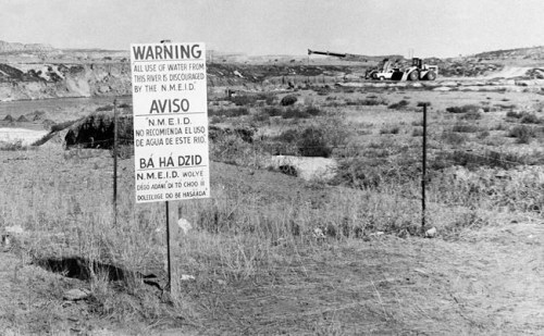 FILE - This Nov. 13, 1975, file photo, shows signs along the Rio Puerco warning residents in three languages to avoid the water in Church Rock, N.M. after a uranium tailings spill. A group representing Navajo communities is presenting its case to an international human rights body, saying U.S. regulators violated the rights of tribal members when they cleared the way for uranium mining in western New Mexico. (AP Photo/SMH,File)