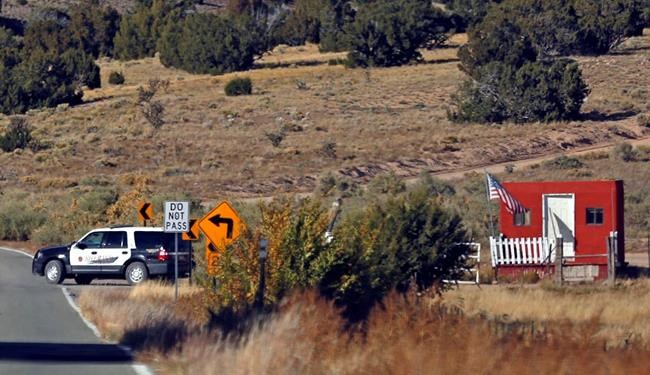 The Santa Fe County Sheriff's Officers respond to the scene of a fatal accidental shooting at a Bonanza Creek Ranch movie set near Santa Fe, N.M. Thursday, Oct. 21, 2021. Authorities say a woman has been killed and a man injured Thursday after they were shot by a prop firearm at a movie set outside Santa Fe. The Santa Fe County Sheriff's Office says a 42-year-old woman was airlifted to a hospital, where she died, while a 42-year-old man was getting emergency care at another hospital. (Luis Sanchez-Saturno/Santa Fe New Mexican via AP)