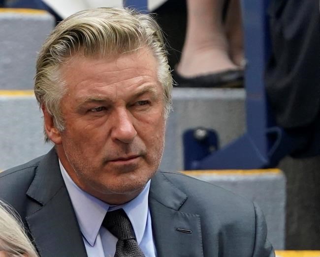 FILE - In this Sunday, Sept. 12, 2021, photo Alec Baldwin watches the men's singles final of the US Open tennis championships in New York. A prop firearm discharged by veteran actor Alec Baldwin, who is starring and producing a Western movie, killed his director of photography and injured the director Thursday, Oct. 21, 2021 at the movie set outside Santa Fe, N.M., the Santa Fe County Sheriff’s Office said.(AP Photo/John Minchillo, File)