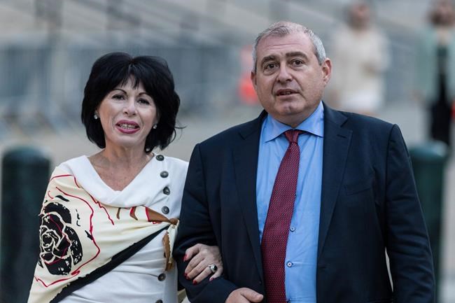 ADDS NAME OF SISTER LUDA PARNAS - Lev Parnas, right, and his sister Luda Parnas leave federal court following closing arguments in his trial Thursday, Oct. 21, 2021, in New York. Parnas, an associate of Rudy Giuliani, hatched a scheme to funnel $1 million in funds from a wealthy Russian financier into U.S. elections knowing full well he was breaking campaign finance laws, a prosecutor said during closing arguments. (AP Photo/Stefan Jeremiah)