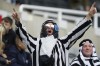 Newcastle fans wait for the start of an English Premier League soccer match between Newcastle and Tottenham Hotspur at St. James' Park in Newcastle, England, Sunday Oct. 17, 2021. Newcastle plays its first game under new ownership after the club was bought out last week by Saudi Arabia's sovereign wealth fund. (AP Photo/Jon Super)