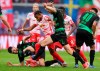 Furth's players Maximilian Bauer, on the ground, Sebastian Griesbeck, centre and Jamie Leweling , right, fight for the ball with Leipzig's Christopher Nkunku centre left and Amadou Haidara centre right, during the German Bundesliga soccer match between RB Leipzig and SpVgg Greuther Fürth, at the Red Bull Arena, in Leipzig, Germany, Saturday, Oct. 23, 2021. (Jan Woitas/dpa-Zentralbild via AP)