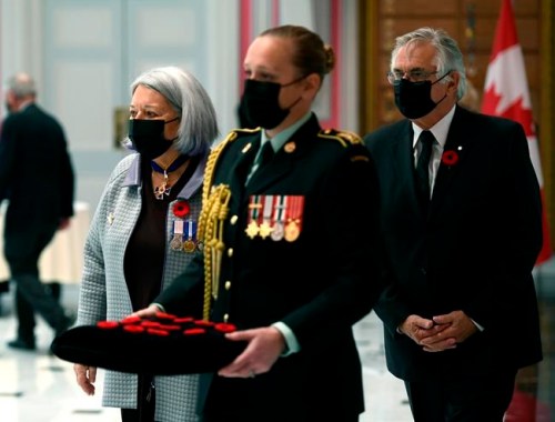 Gov. Gen. Mary Simon and her husband Whit Fraser walk to present veterans at the launch of the National Poppy Campaign at Rideau Hall in Ottawa, on Monday, Oct. 25, 2021. THE CANADIAN PRESS/Justin Tang