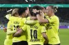 Borussia Dortmund players celebrate after Dortmund's Thorgan Hazard, centre, scored his side's opening goal during the German Soccer Cup match between Borussia Dortmund and FC Ingolstadt 04 in Dortmund, Germany, Tuesday, Oct. 26, 2021. (AP Photo/Martin Meissner)