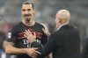 AC Milan's manager Stefano Pioli, right, cheers AC Milan's Zlatan Ibrahimovic end of the Serie A soccer match between AC Milan and Torino, at the San Siro stadium, in Milan, Italy, Tuesday, Oct. 26, 2021. (AP Photo/Luca Bruno)