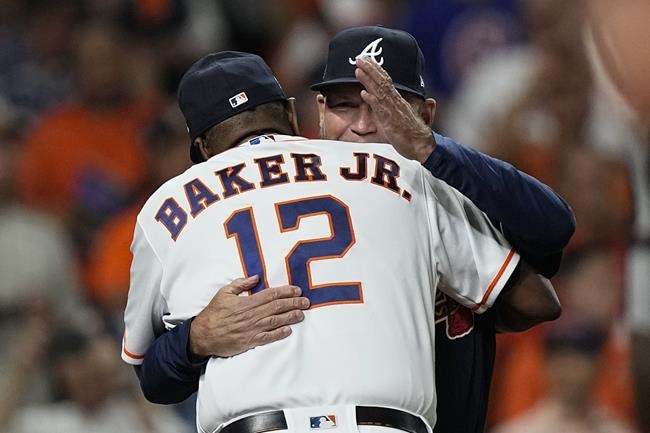 Atlanta Braves manager Brian Snitker hugs Houston Astros manager Dusty Baker Jr. before Game 1 in baseball's World Series between the Houston Astros and the Atlanta Braves Tuesday, Oct. 26, 2021, in Houston. (AP Photo/David J. Phillip)