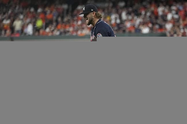 Atlanta Braves relief pitcher A.J. Minter celebrates the end of the third inning of Game 1 in baseball's World Series between the Houston Astros and the Atlanta Braves Tuesday, Oct. 26, 2021, in Houston. (AP Photo/Ashley Landis)