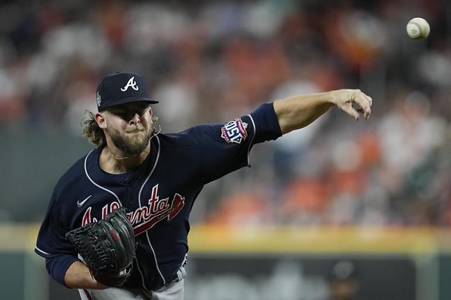 Atlanta Braves relief pitcher A.J. Minter throws during the third inning of Game 1 in baseball's World Series between the Houston Astros and the Atlanta Braves Tuesday, Oct. 26, 2021, in Houston. (AP Photo/Ashley Landis)