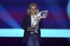 England head coach Sarina Wiegman holds the trophy during the UEFA Women's Euro 2022 soccer draw at O2 Victoria Warehouse in Manchester, England, Thursday, Oct. 28, 2021. (Nick Potts/PA via AP)