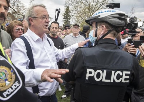 Randy Hillier, independent MPP for Lanark-Frontenac-Kingston argues with police at a protest against government measures to curb the spread of COVID-19, in Peterborough, Ont., on April 24, 2021. THE CANADIAN PRESS/Fred Thornhill