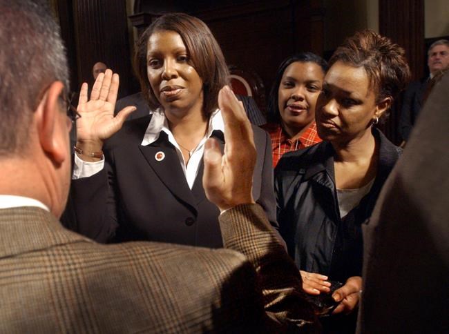 FILE — In this Nov. 19, 2003 file photo, Letitia James, second from left, takes the oath as the newest elected city council member at New York City Hall, replacing slain city council member James Davis. Letitia James formally announced Friday, Oct. 29, 2021, that she is running for governor, a widely anticipated move from the woman who oversaw an investigation into allegations that former Gov. Andrew Cuomo sexually harassed numerous women. (AP Photo/Bebeto Matthews, File)