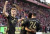 Bayern's Kingsley Coman, center, celebrates with Thomas Mueller, left, and Corentin Tolisso after scoring his side's fourth goal during the German Bundesliga soccer match between 1. FC Union Berlin and FC Bayern Munich in Berlin, Germany, Saturday, Oct. 30, 2021. (AP Photo/Michael Sohn)