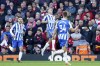 Brighton's Leandro Trossard, center, celebrates after scoring his side's second goal during the English Premier League soccer match between Liverpool and Brighton and Hove Albion at Anfield Stadium, Liverpool, England, Saturday, Oct. 30, 2021. (AP Photo/Jon Super)