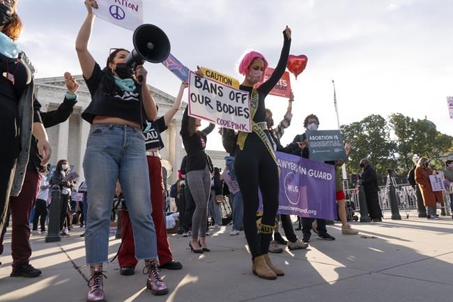 Pro-choice and anti-abortion activists rally outside the Supreme Court, Monday, Nov. 1, 2021, as arguments are set to begin about abortion by the court, on Capitol Hill in Washington. (AP Photo/Jacquelyn Martin)
