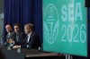 Colin Smith, right, FIFA chief tournaments and events chairman, speaks Monday, Nov. 1, 2021, in Seattle as Adrian Hanauer, center, owner of the MLS soccer Seattle Sounders, and Kasey Keller, left, former goalkeeper for the Sounders and the U.S. Men's National Team, look on during a news conference at Lumen Field. Smith was discussing taking part in an official visit of a FIFA delegation to Seattle, as organizers try to be selected as a host city for the FIFA World Cup in 2026. (AP Photo/Ted S. Warren)