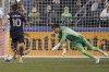 Los Angeles Galaxy goalkeeper Jonathan Bond dives to block a shot by Seattle Sounders midfielder Nicolas Lodeiro (10) during the first half of an MLS soccer match, Monday, Nov. 1, 2021, in Seattle. (AP Photo/Ted S. Warren)