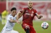 Chicago Fire midfielder Ignacio Aliseda (7) and Toronto FC midfielder Michael Bradley (4) battle for the ball during second half MLS soccer action against the Chicago Fire in Toronto, Sunday, Oct. 3, 2021. THE CANADIAN PRESS/Cole Burston
