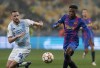 Barcelona's Ansu Fati, right, duels for the ball with Dynamo Kyiv's Tomasz Kedziora during the Champions League group E soccer match between Dynamo Kyiv and Barcelona at the Olimpiyskiy Stadium in Kyiv, Ukraine, Tuesday, Nov. 2, 2021. (AP Photo/Efrem Lukatsky)