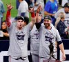 Atlanta Braves' Joc Pederson, left, and Josh Tomlin celebrate the team's win over the Houston Astros in Game 6 of the baseball World Series, Tuesday, Nov. 2, 2021, in Houston. (Kevin M. Cox/The Galveston County Daily News via AP)