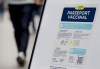 People walk by a sign at a restaurant advising customers of Quebec’s COVID-19 vaccine passport in Montreal, Monday, Sept. 6, 2021. THE CANADIAN PRESS/Graham Hughes