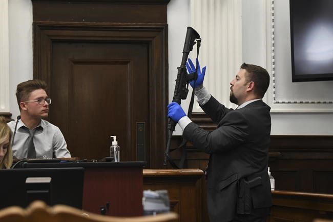Kenosha Police Detective Ben Antaramian, right, shows witness Dominick Black an assault-style rifle that Black bought for defendant Kyle Rittenhouse, during testimony in court, Tuesday Nov. 2, 2021, in Kenosha, Wis. Rittenhouse, an aspiring police officer, shot two people to death and wounded a third during a night of anti-racism protests in Kenosha in 2020. (Mark Hertzberg/Pool Photo via AP)