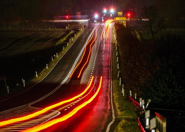 First commuters drive on a land road in Frankfurt, Germany, early Wednesday, Nov. 3, 2021. (AP Photo/Michael Probst)