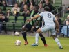 Austin FC forward Moussa Djitte (99) controls the ball against Sporting Kansas City defender Graham Zusi (8) during the first half of an MLS soccer match, Wednesday, Nov. 3, 2021, in Austin, Texas. (AP Photo/Michael Thomas)
