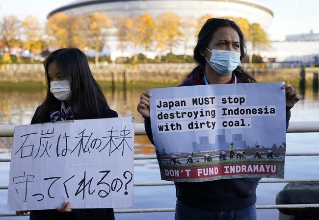 Activists protest against Japan's support of the coal industry near the COP26 U.N. Climate Summit in Glasgow, Scotland, Thursday, Nov. 4, 2021. The U.N. climate summit in Glasgow gathers leaders from around the world, in Scotland's biggest city, to lay out their vision for addressing the common challenge of global warming. (AP Photo/Alberto Pezzali)